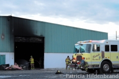 1.19.11..Patricia Hildenbrand Photo..Members of the Hurlock Fire Department and surrounding areas work to put out a blaze that damaged the main warehouse of the Black Gold Potato Farm in Rhodesdale. Fourteen fire companies and one hundred firefighters responded to the three-alarm fire.  No injuries have been reported and the cause of the fire is still under investigation.