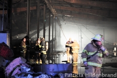 1.19.11..Patricia Hildenbrand Photo..Firefighters inspect a building after putting out a blaze that damaged the main warehouse of the Black Gold Potato Farm in Rhodesdale. Fourteen fire companies and one hundred firefighters responded to the three-alarm fire.  No injuries have been reported and the cause of the fire is still under investigation.