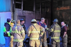 1.19.11..Patricia Hildenbrand Photo..Firefighters inspect a building after putting out a blaze that damaged the main warehouse of the Black Gold Potato Farm in Rhodesdale. Fourteen fire companies and one hundred firefighters responded to the three-alarm fire.  No injuries have been reported and the cause of the fire is still under investigation.