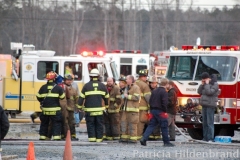 1.19.11..Patricia Hildenbrand Photo..Firefighters discuss the possible cause of a blaze that damaged the main warehouse of the Black Gold Potato Farm in Rhodesdale. Fourteen fire companies and one hundred firefighters responded to the three-alarm fire.  No injuries have been reported and the cause of the fire is still under investigation.